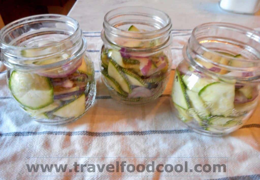 Pack zucchini and onions into sterilized jars